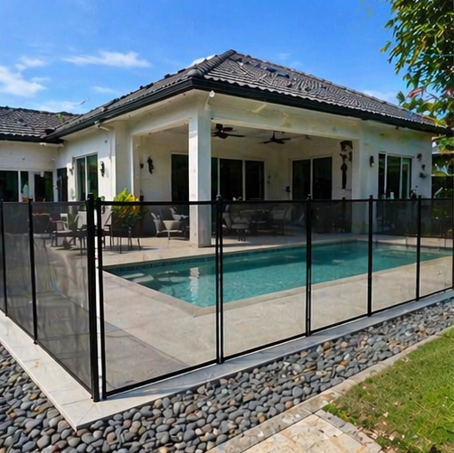 Black mesh pool fencing beside a backyard patio